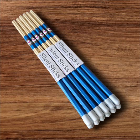 A brick containing 6 pairs of Silent Sticks 7-dowel hot rod drumsticks with blue grip and white end caps. Low volume practice drum rods for apartments and low-volume acoustic gigs.