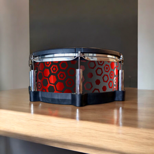 Close-up of a snare drum with a newly installed black and chrome red hexagonal fade vinyl wrap on a Roland PSD-140DS digital snare drum, showcasing the detailed texture and professional finish, ideal for drummers seeking to upgrade their drum kit's aesthetics.