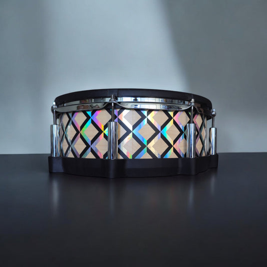 Close-up of a snare drum with a newly installed maple, black and holographic vinyl wrap on a Roland PD-140DS snare drum, showcasing the detailed texture and professional finish, ideal for drummers seeking to upgrade their drum kit's aesthetics.