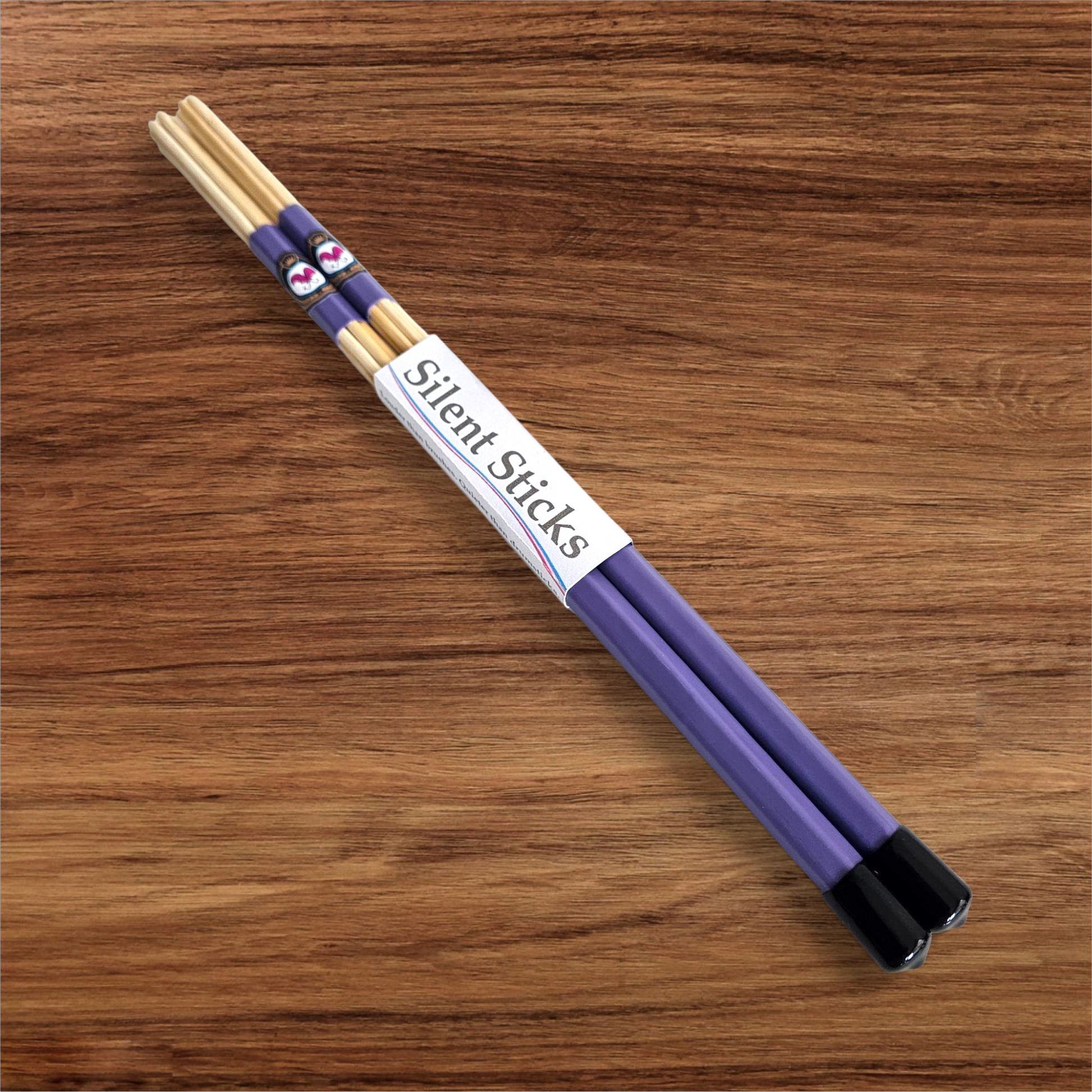 A single pair of custom Silent Sticks 7-dowel hot rod drumsticks with purple grip and black end caps. Low volume practice drum rods for apartments and low-volume acoustic gigs.