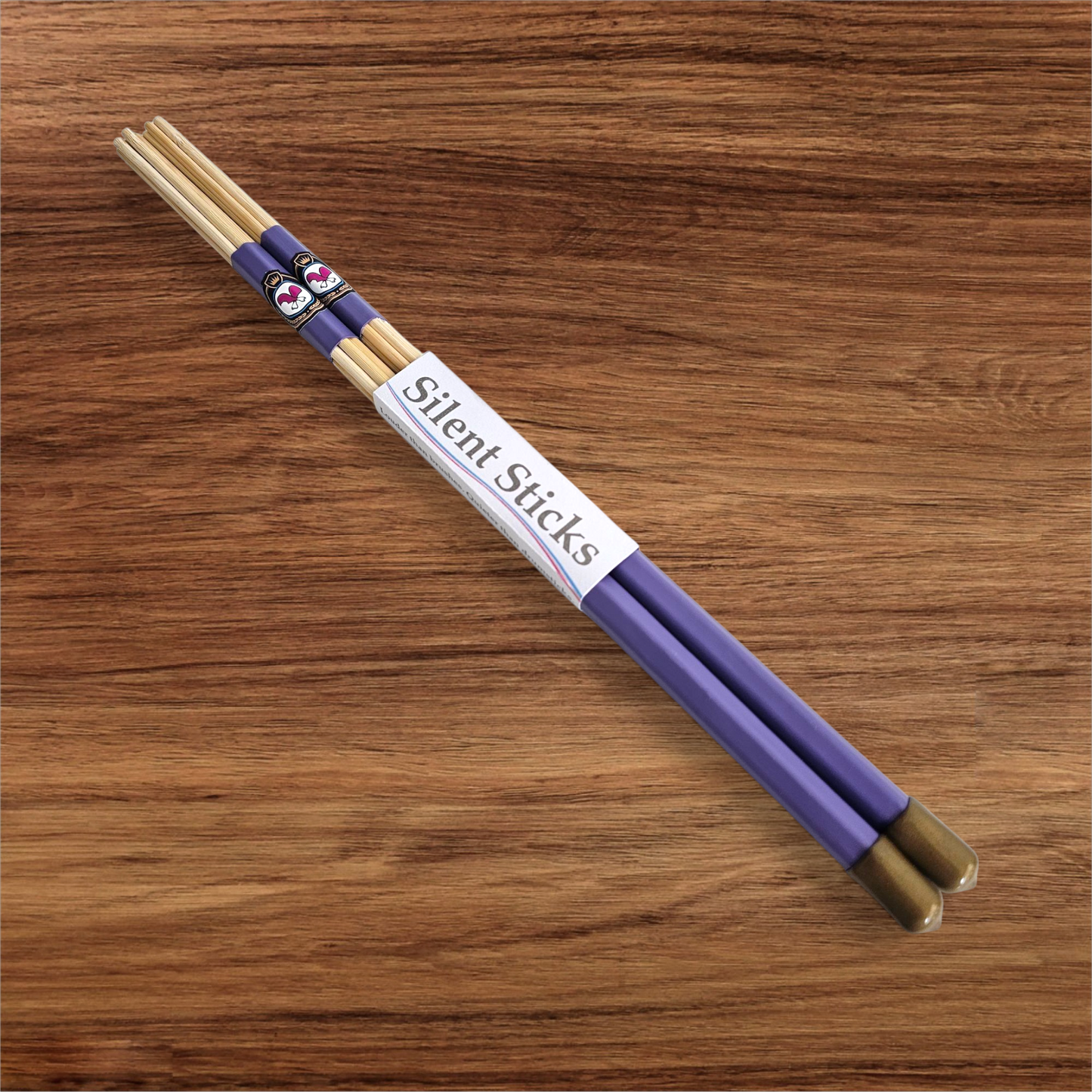 A single pair of custom Silent Sticks 7-dowel hot rod drumsticks with purple grip and gold end caps. Low volume practice drum rods for apartments and low-volume acoustic gigs.