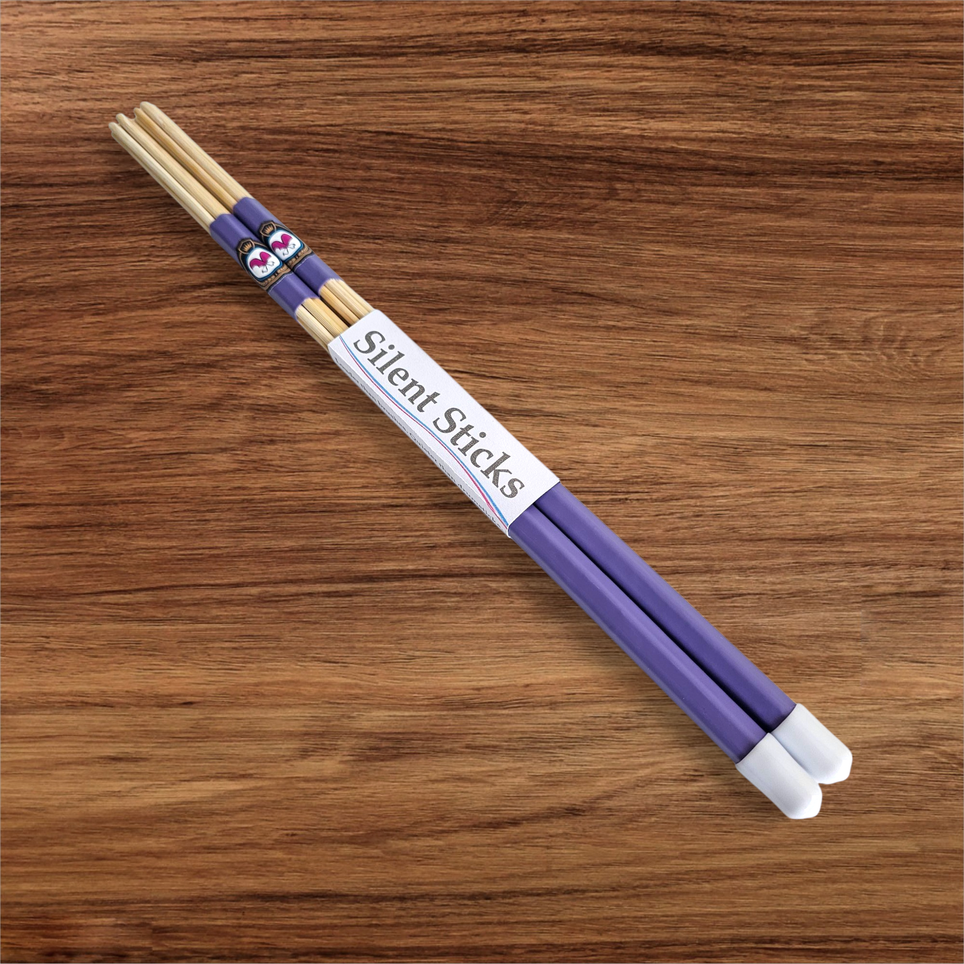 A single pair of custom Silent Sticks 7-dowel hot rod drumsticks with purple grip and white end caps. Low volume practice drum rods for apartments and low-volume acoustic gigs.