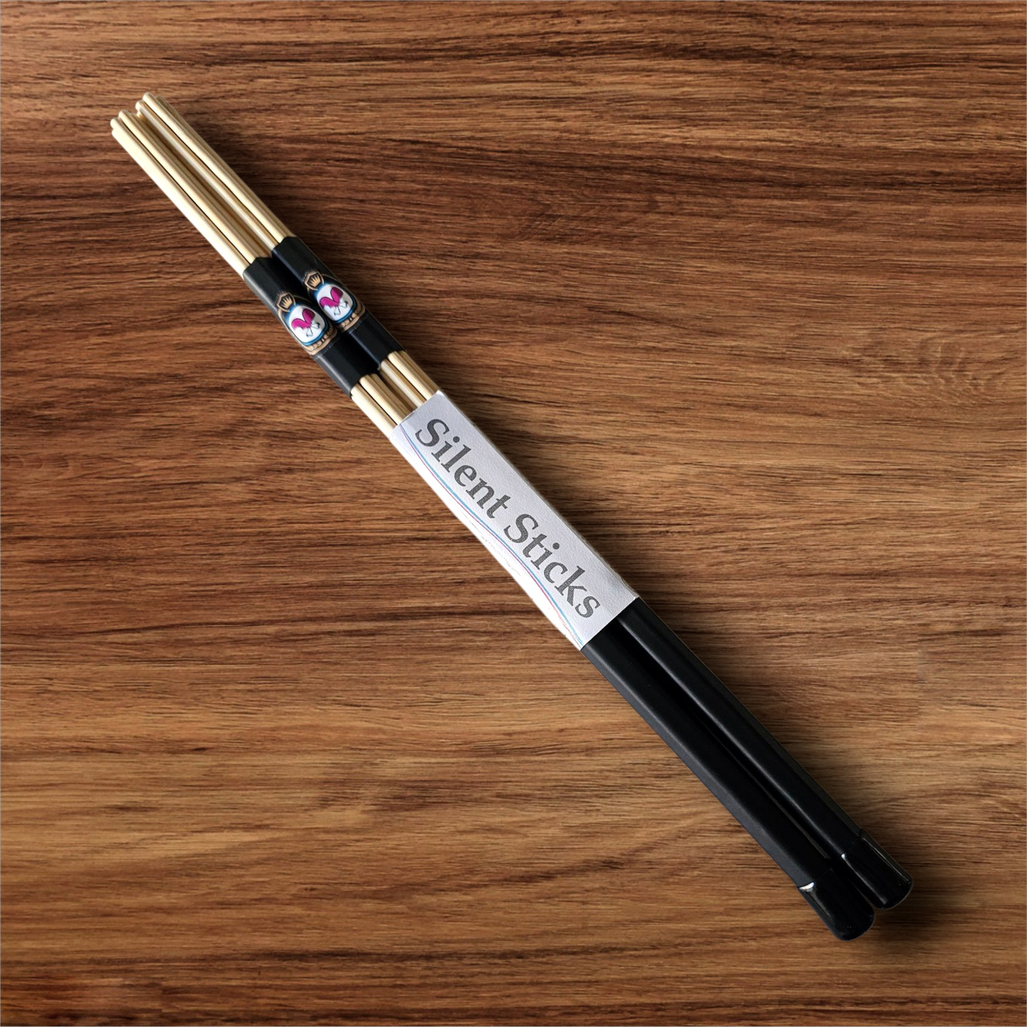 A single pair of custom Silent Sticks 7-dowel hot rod drumsticks with black grip and black end caps. Low volume practice drum rods for apartments and low-volume acoustic gigs.