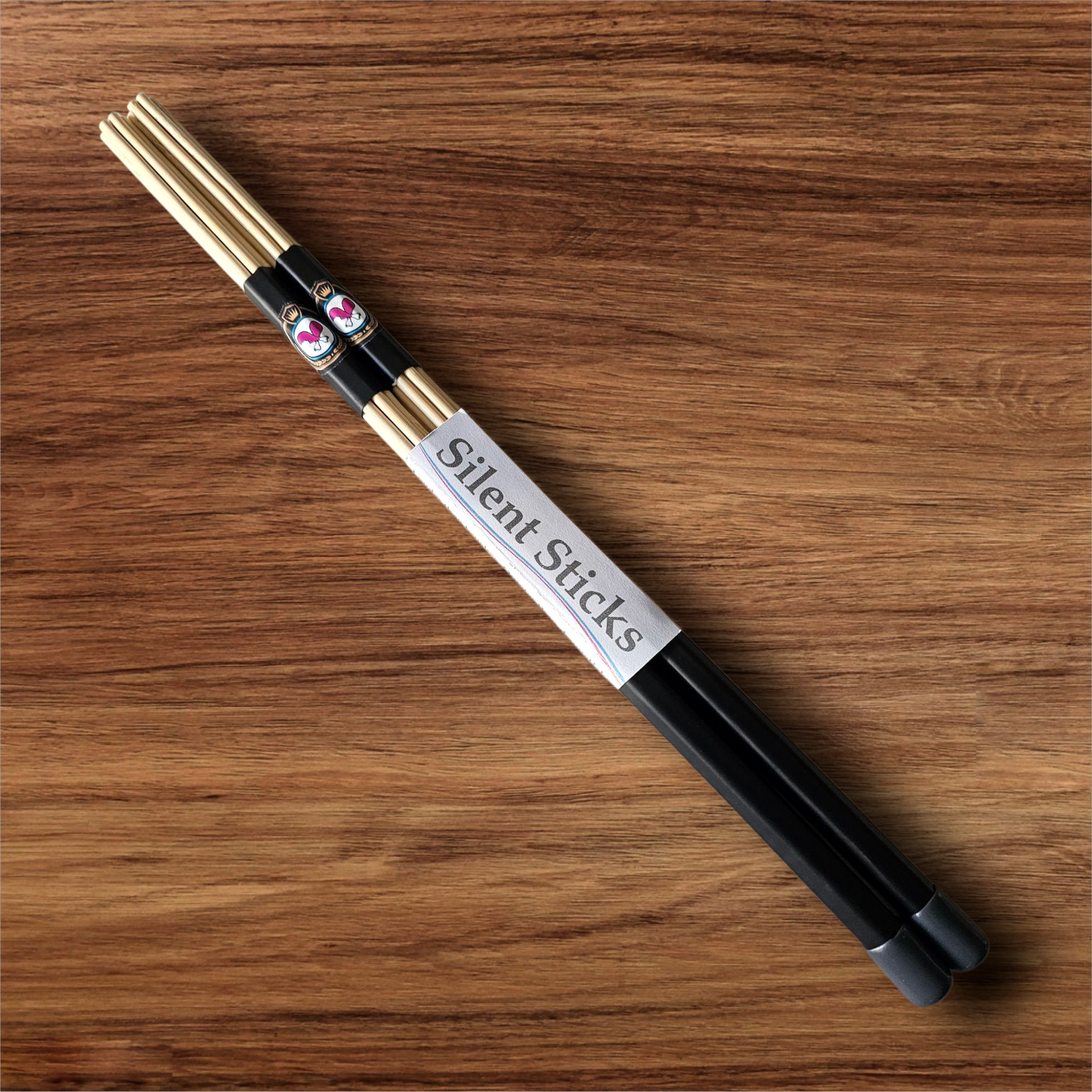 A single pair of custom Silent Sticks 7-dowel hot rod drumsticks with black grip and grey end caps. Low volume practice drum rods for apartments and low-volume acoustic gigs.