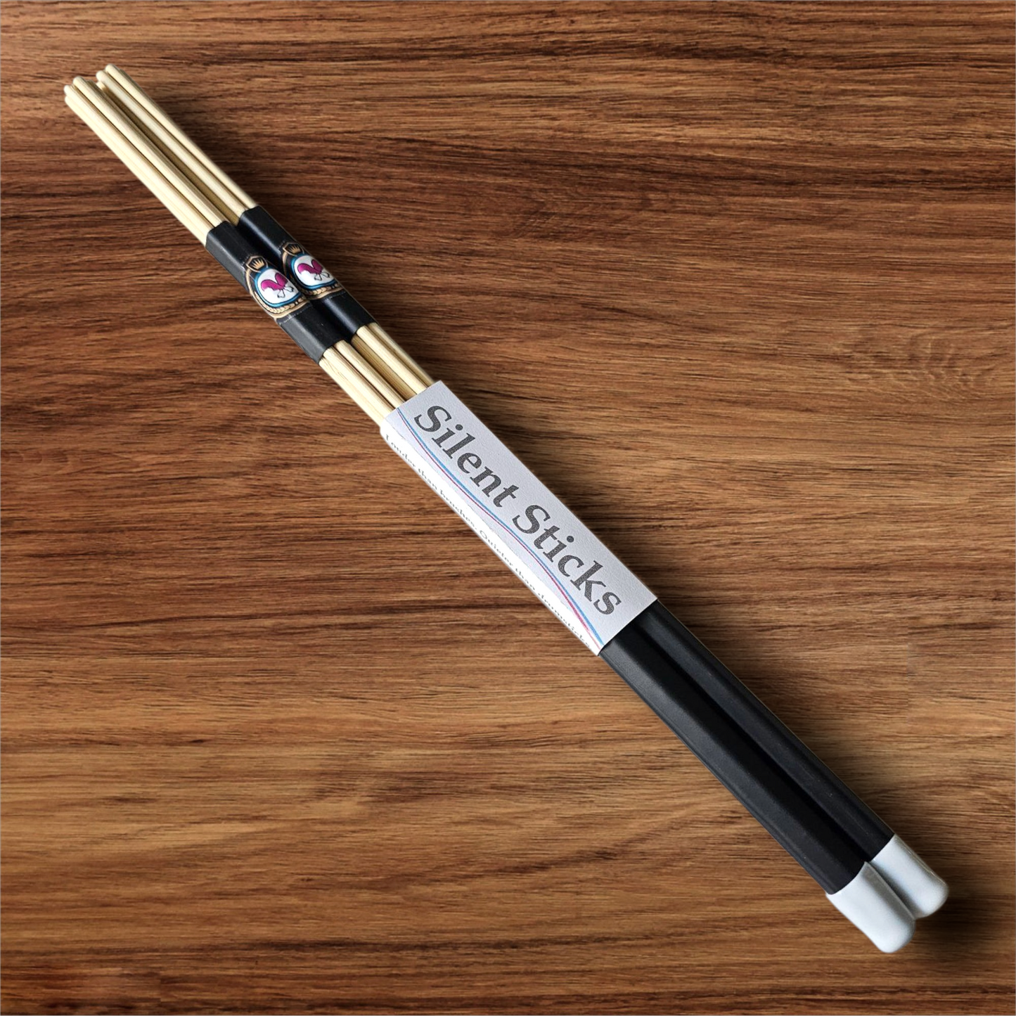 A single pair of custom Silent Sticks 7-dowel hot rod drumsticks with black grip and white end caps. Low volume practice drum rods for apartments and low-volume acoustic gigs.