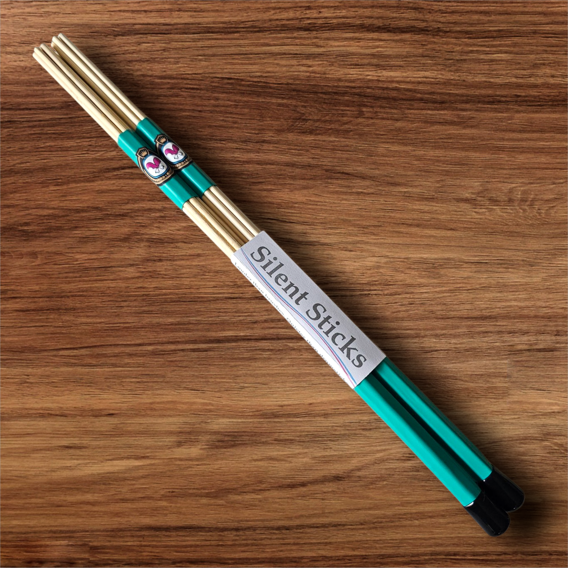 A single pair of custom Silent Sticks 7-dowel hot rod drumsticks with green grip and black end caps. Low volume practice drum rods for apartments and low-volume acoustic gigs.