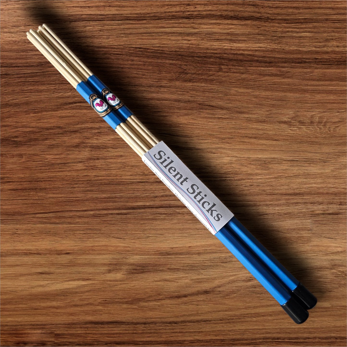 A single pair of custom Silent Sticks 7-dowel hot rod drumsticks with blue grip and black end caps. Low volume practice drum rods for apartments and low-volume acoustic gigs.