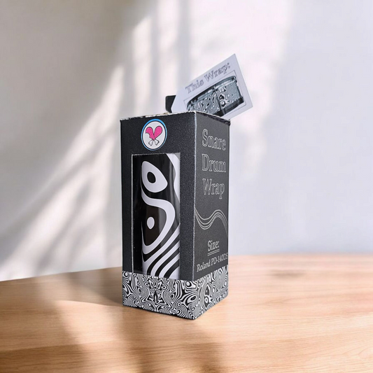 Vinyl snare drum wrap in its retail box packaging, highlighting the product's branding and secure packaging for drummers looking to enhance their snare drum's appearance.