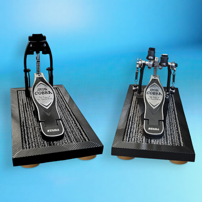 Carbon fiber 2x single pedal Silent Stomper impact noise isolation platform pack designed for drummers, enabling quiet practice in enclosed spaces like apartment buildings by reducing/eliminating vibrations and preventing noise disturbances for neighbors.