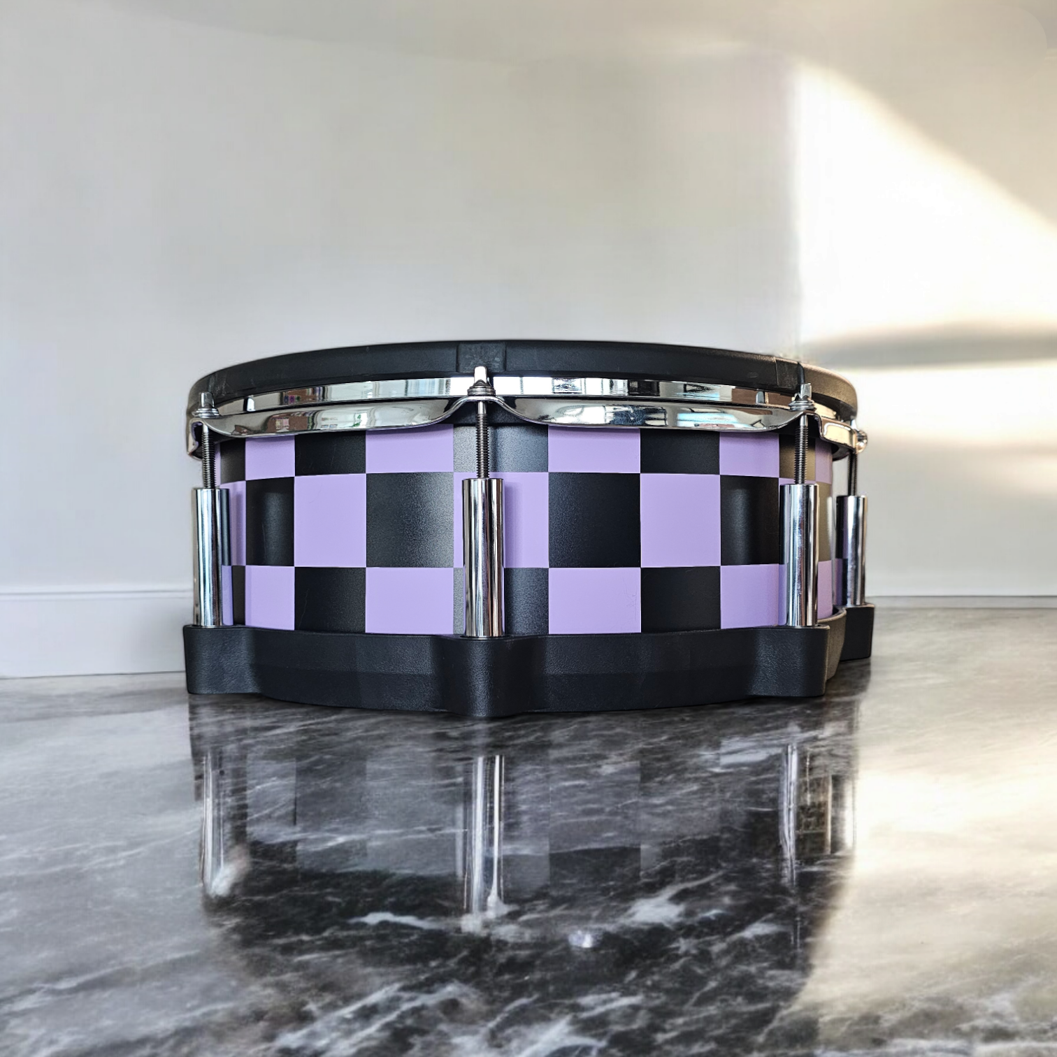 Close-up of a snare drum with a newly installed black and matte lavender purple vinyl wrap on a Roland PD-140DS snare drum, showcasing the detailed texture and professional finish, ideal for drummers seeking to upgrade their drum kit's aesthetics.