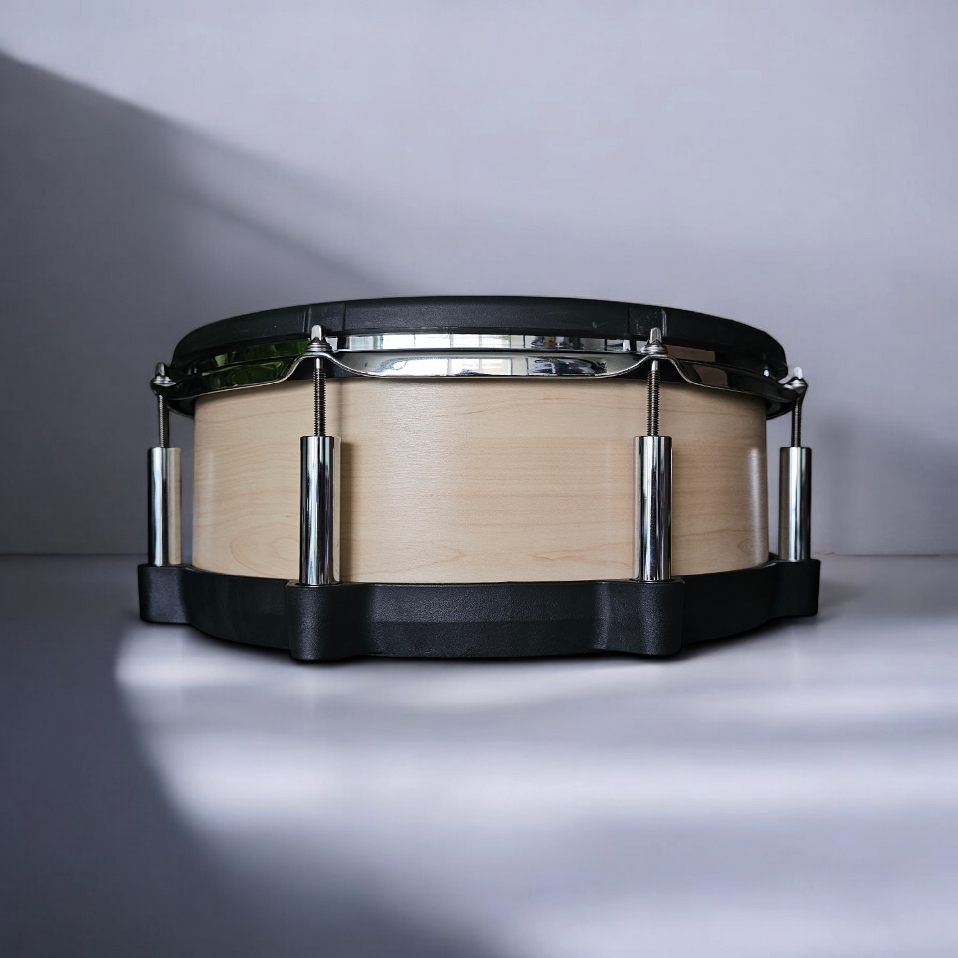 Close-up of a snare drum with a newly installed maple wood grain vinyl wrap on a Roland PD-140DS snare drum, showcasing the detailed texture and professional finish, ideal for drummers seeking to upgrade their drum kit's aesthetics.