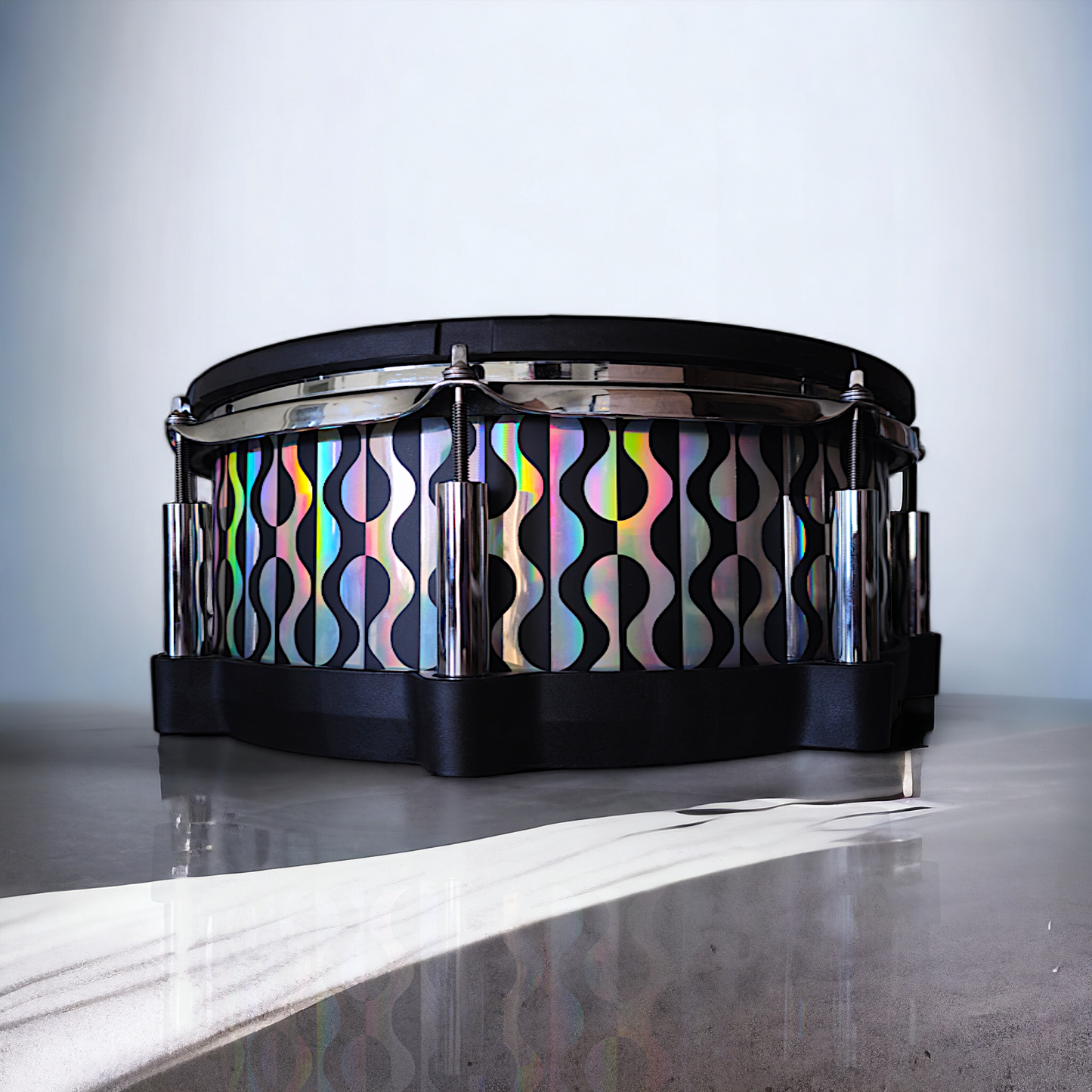 Close-up of a snare drum with a newly installed black and holographic vinyl wrap on a Roland PD-140DS snare drum, showcasing the detailed texture and professional finish, ideal for drummers seeking to upgrade their drum kit's aesthetics.