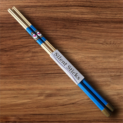 A single pair of custom Silent Sticks 7-dowel hot rod drumsticks with blue grip and gold end caps. Low volume practice drum rods for apartments and low-volume acoustic gigs.